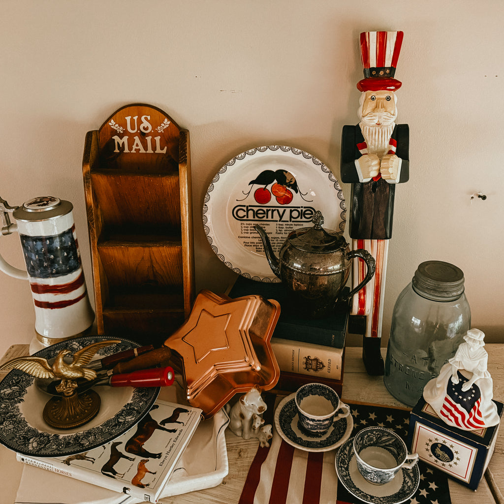 Collection of vintage and decorative items including a wooden 'US Mail' holder, ceramic teapot, and patriotic figurines.
