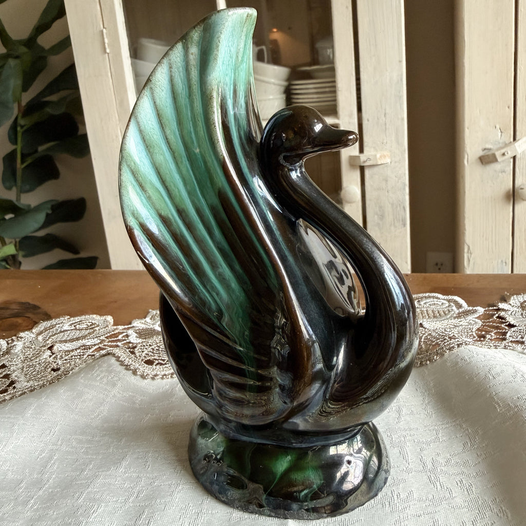 Reverse side profile of the swan vase, highlighting the textured wing and glossy black finish.