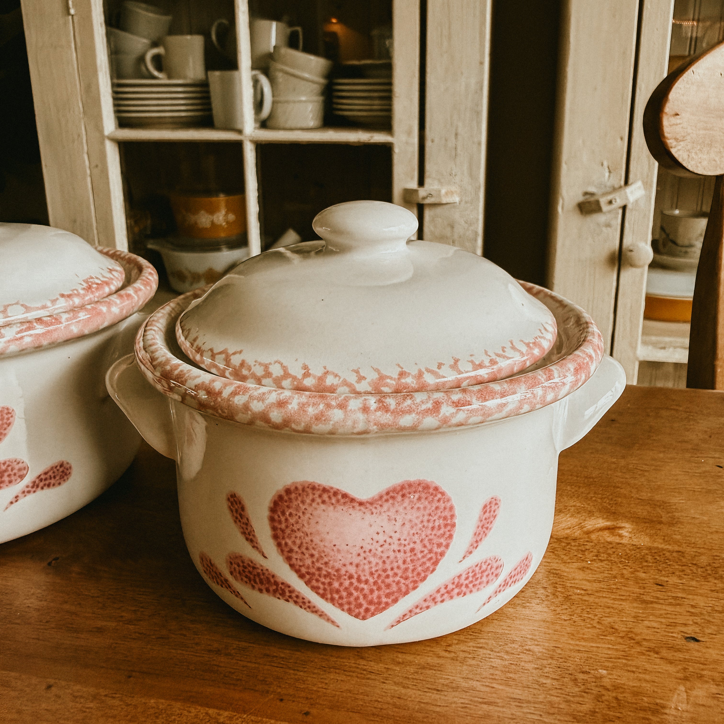 Two 5" lidded individual casserole dishes with pink heart designs