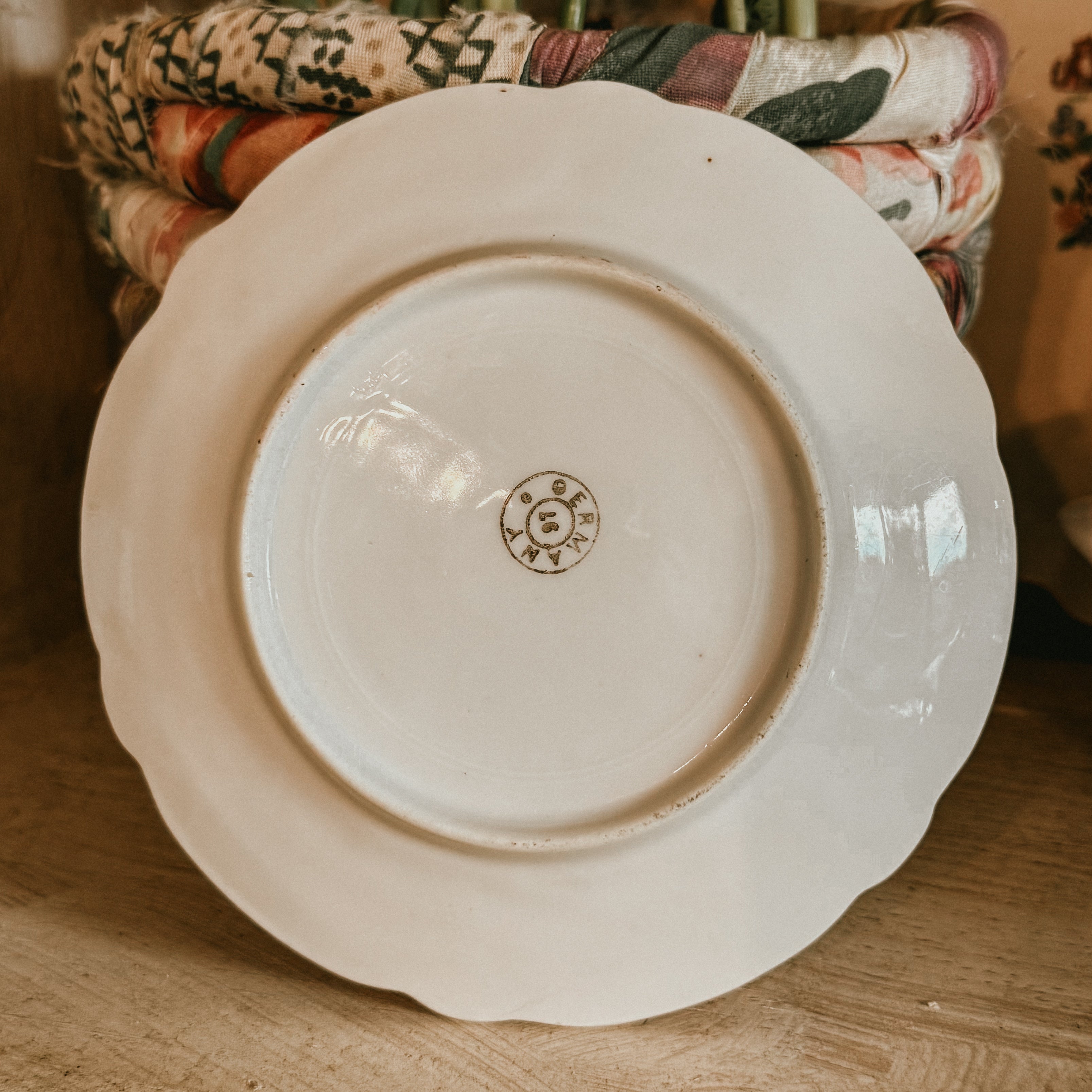 Authentic circular pottery backstamp mark reading GERMANY with mold number 91 on the underside of an antique porcelain plate.